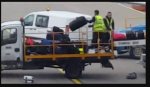 Baggage handler filmed lobbing luggage.JPG